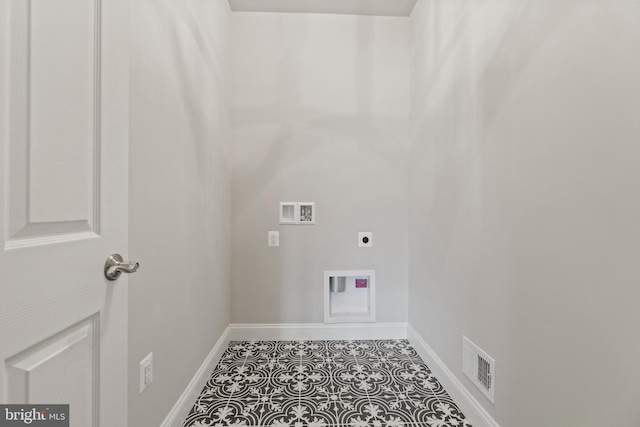 clothes washing area featuring hookup for an electric dryer, hookup for a washing machine, and tile patterned flooring