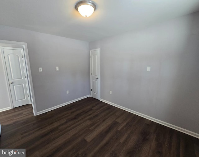 empty room featuring dark wood-type flooring