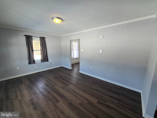 spare room with dark wood-type flooring and ornamental molding