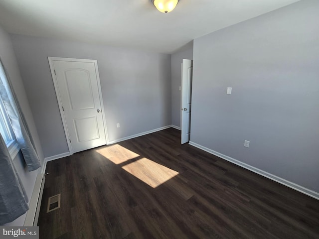 unfurnished room featuring dark wood-type flooring