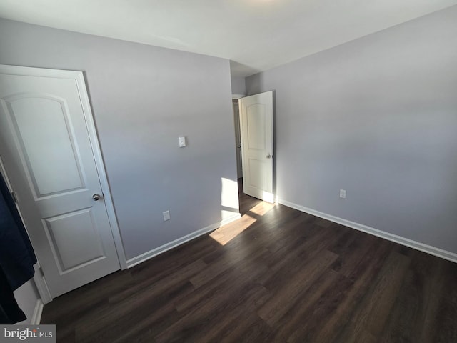 unfurnished bedroom featuring dark wood-type flooring