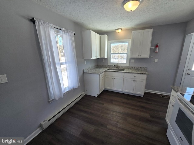 kitchen featuring a baseboard radiator, sink, dark wood-type flooring, white cabinetry, and electric stove