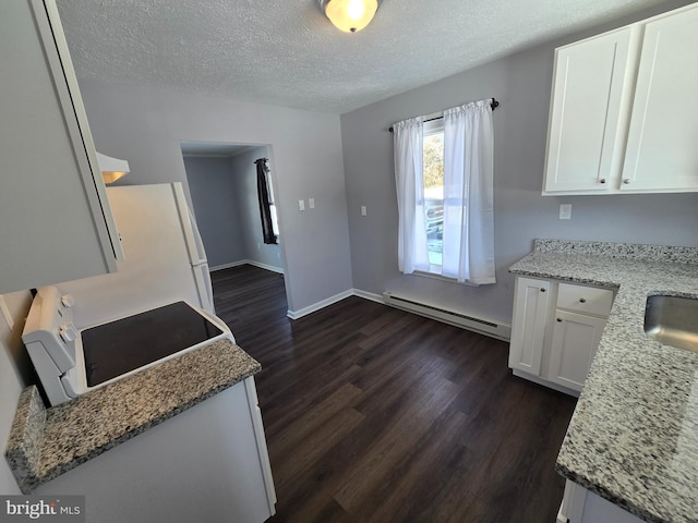 kitchen with light stone counters, a baseboard radiator, and white cabinets