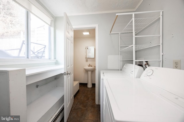 clothes washing area featuring independent washer and dryer, sink, a textured ceiling, and dark tile patterned floors