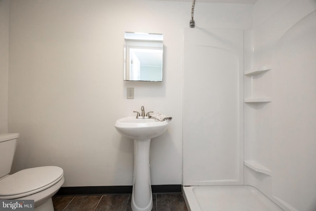 bathroom with walk in shower and toilet