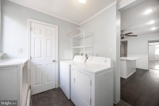 laundry room with ceiling fan, a baseboard heating unit, dark hardwood / wood-style floors, independent washer and dryer, and ornamental molding