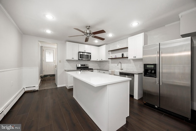 kitchen featuring white cabinetry, stainless steel appliances, a center island, and sink