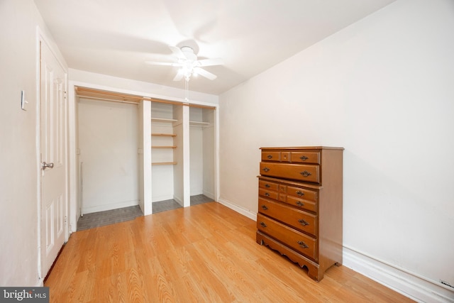 bedroom with ceiling fan, a closet, and light hardwood / wood-style flooring