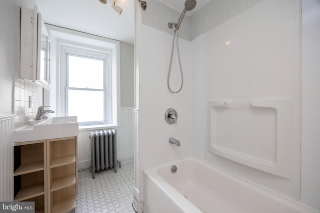 bathroom with tub / shower combination and radiator heating unit