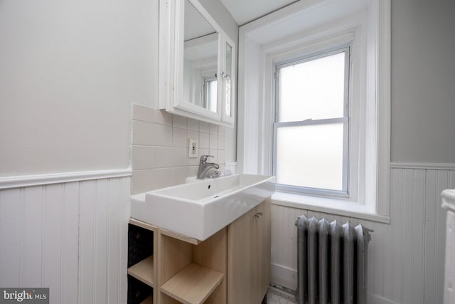 bathroom featuring radiator and sink