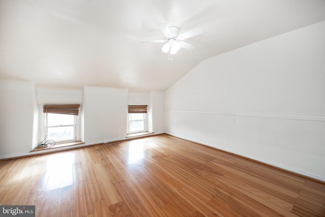 interior space featuring ceiling fan, lofted ceiling, light hardwood / wood-style floors, and a wealth of natural light