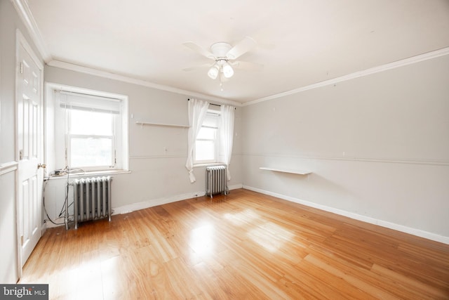 unfurnished room featuring radiator, crown molding, wood-type flooring, and ceiling fan