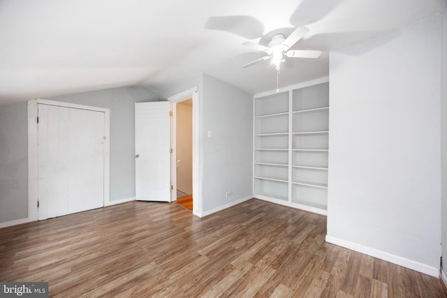 unfurnished bedroom with vaulted ceiling, ceiling fan, and hardwood / wood-style floors