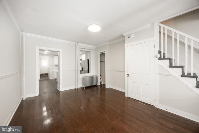 interior space featuring dark wood-type flooring, crown molding, and radiator