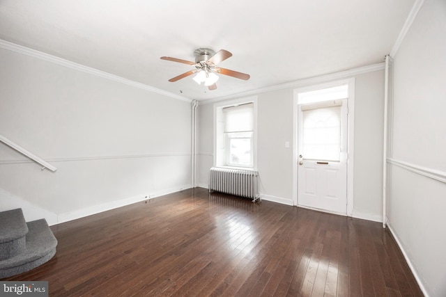 unfurnished room featuring ornamental molding, dark hardwood / wood-style floors, radiator heating unit, and ceiling fan