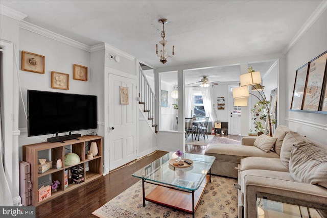 living room with ornamental molding, dark hardwood / wood-style floors, and a notable chandelier