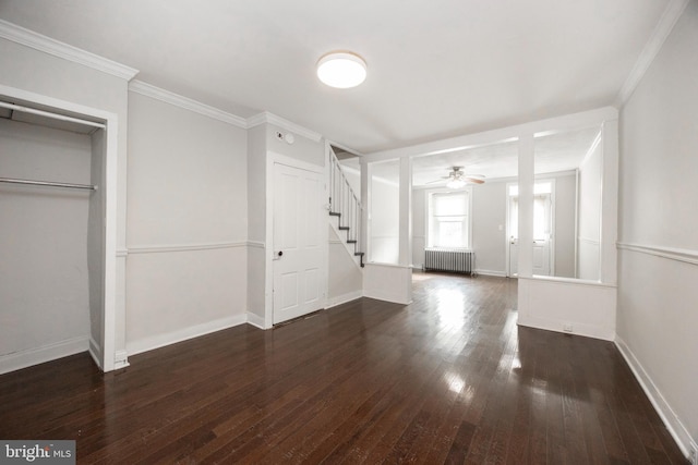 foyer entrance with crown molding, ceiling fan, radiator heating unit, and dark hardwood / wood-style flooring