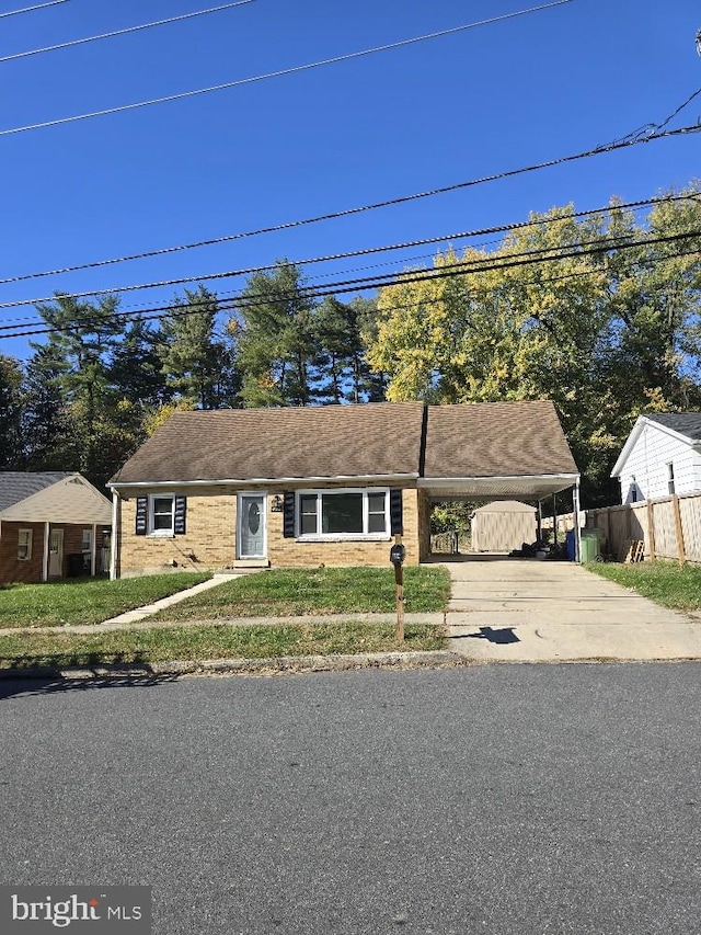 view of front facade with a front yard and a carport