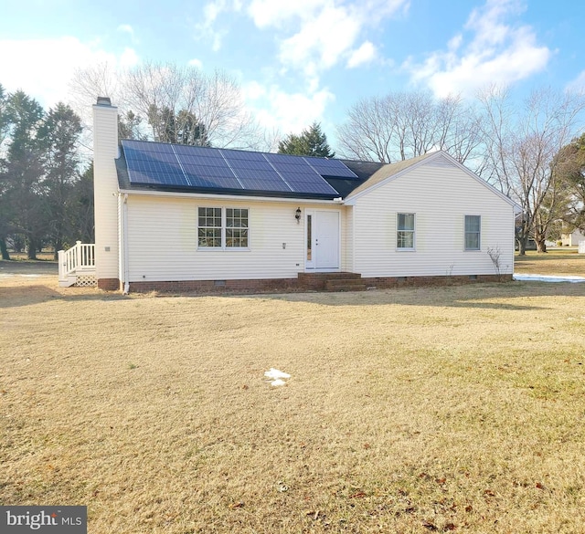 single story home featuring a front yard and solar panels