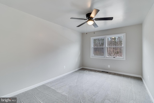 carpeted empty room with ceiling fan