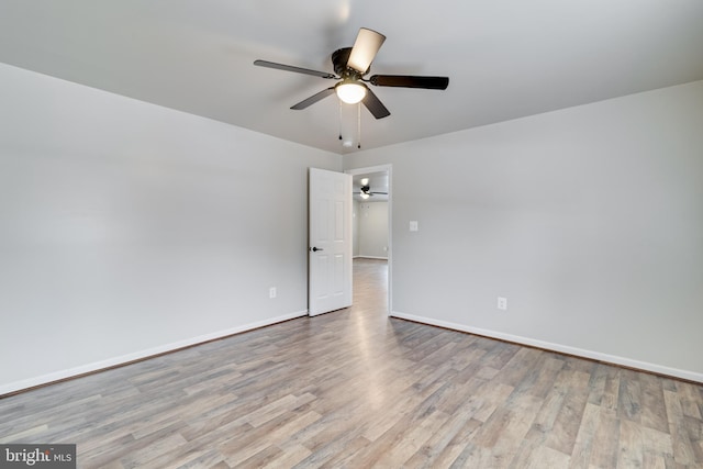 empty room featuring light hardwood / wood-style flooring and ceiling fan