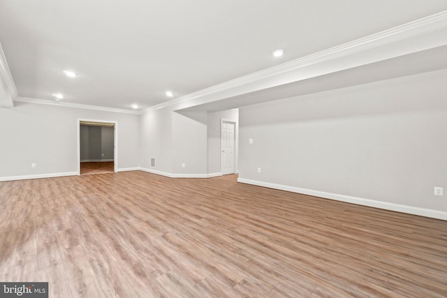 interior space with light hardwood / wood-style floors and ornamental molding