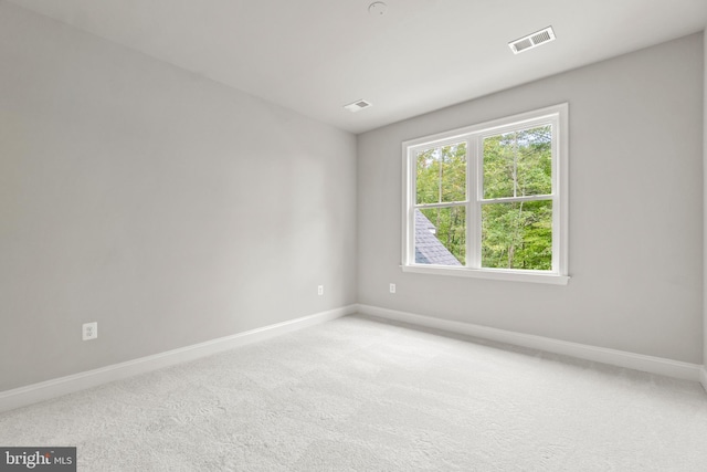 unfurnished room with light carpet