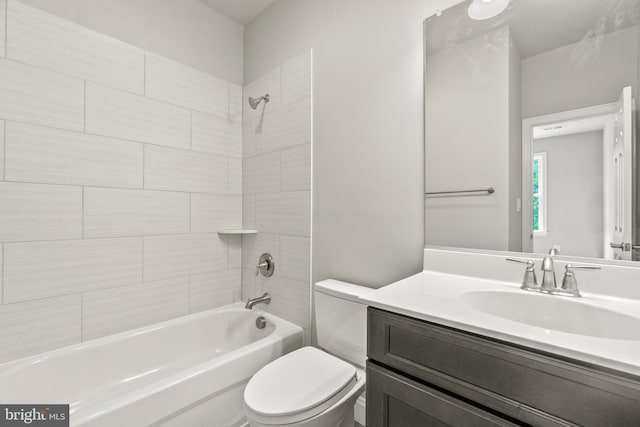 full bathroom featuring vanity, toilet, and tiled shower / bath combo