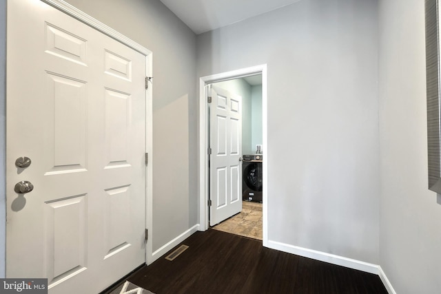 corridor with dark hardwood / wood-style flooring