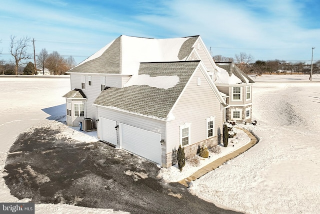 view of home's exterior featuring central AC and a garage