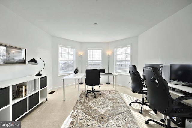 carpeted office space featuring a wealth of natural light