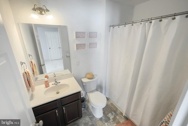 bathroom with toilet and vanity