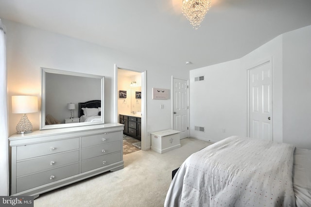 carpeted bedroom with ensuite bathroom