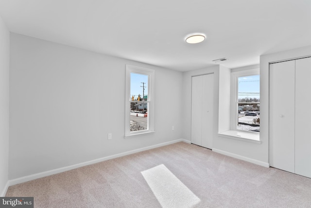 spare room with light colored carpet