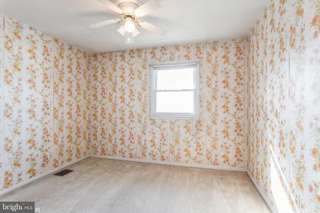 carpeted empty room featuring ceiling fan