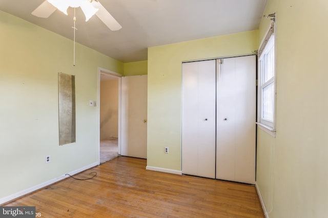 unfurnished bedroom with ceiling fan, a closet, and light hardwood / wood-style flooring