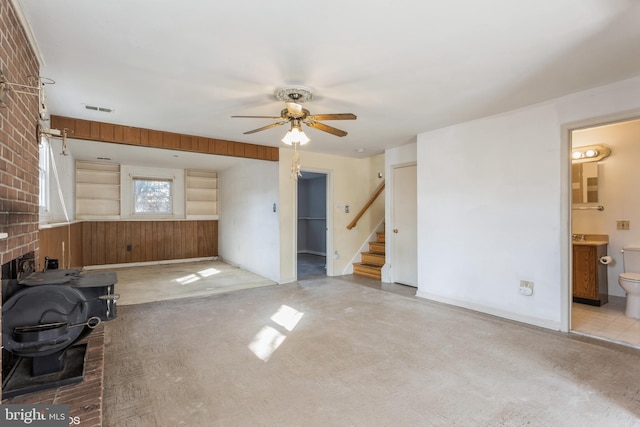 unfurnished living room with ceiling fan