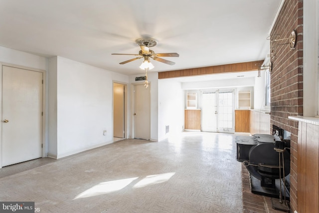 unfurnished living room featuring ceiling fan