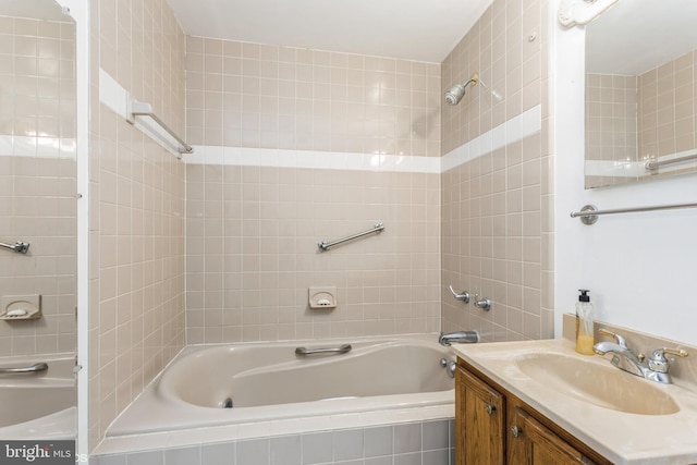 bathroom featuring vanity and tiled shower / bath combo