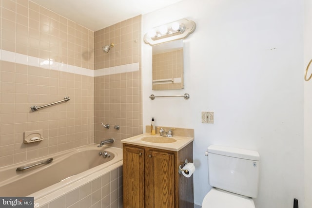 full bathroom with vanity, tiled shower / bath, and toilet