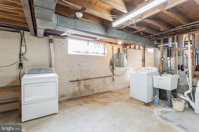 basement with washing machine and dryer and sink