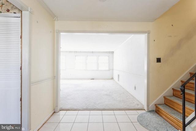 hallway featuring crown molding and light carpet