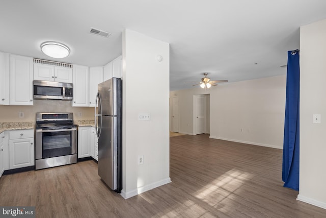 kitchen featuring ceiling fan, dark wood-type flooring, white cabinets, and appliances with stainless steel finishes