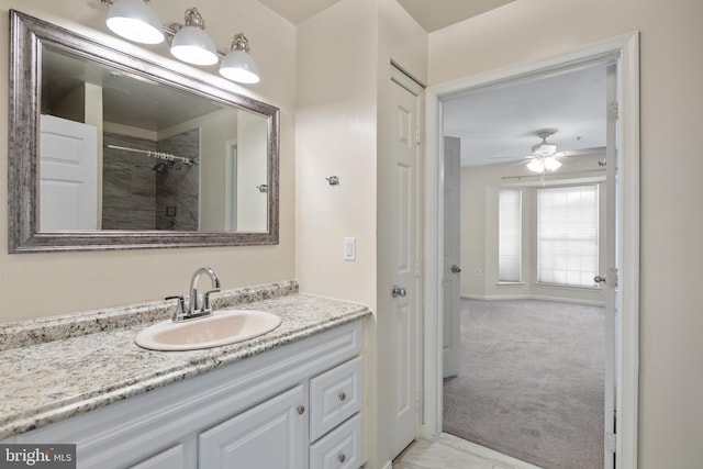 bathroom featuring vanity, a shower, and ceiling fan