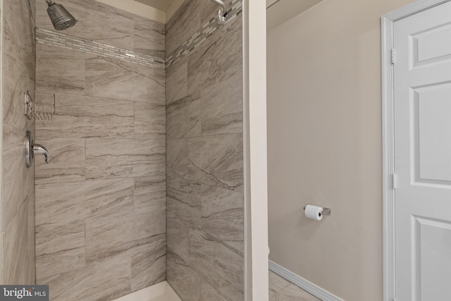 bathroom with a tile shower