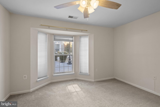 spare room with carpet and ceiling fan