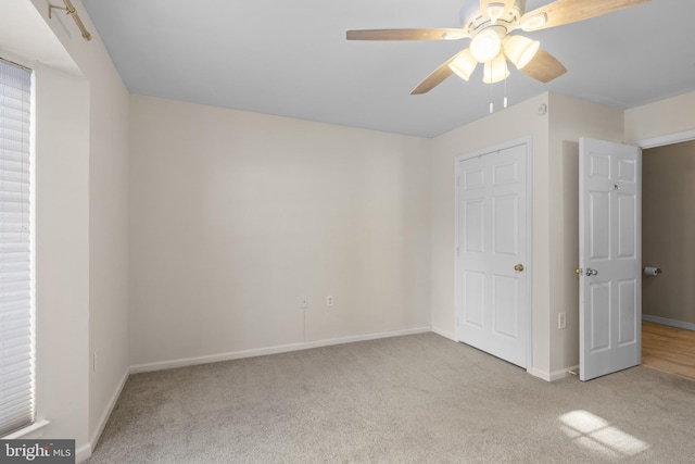 unfurnished bedroom with light colored carpet and ceiling fan