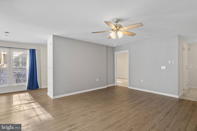 empty room with hardwood / wood-style flooring and ceiling fan