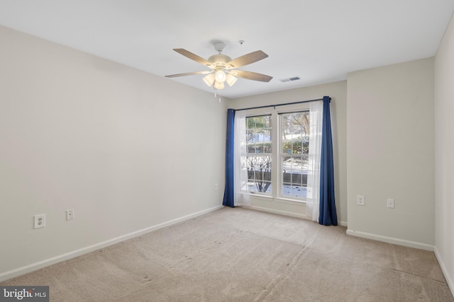 carpeted spare room with ceiling fan