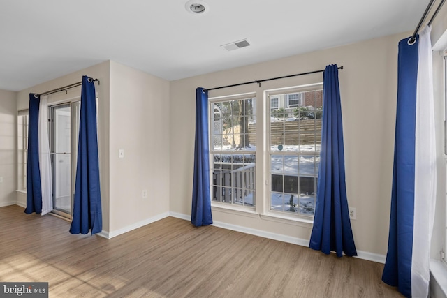 unfurnished room with hardwood / wood-style flooring